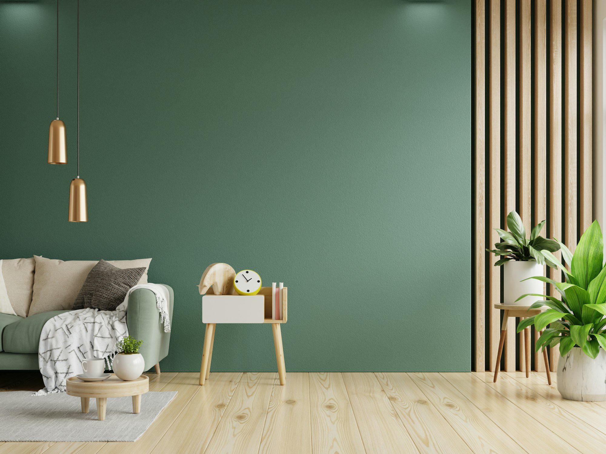Green sofa with table on green wall and wooden flooring.